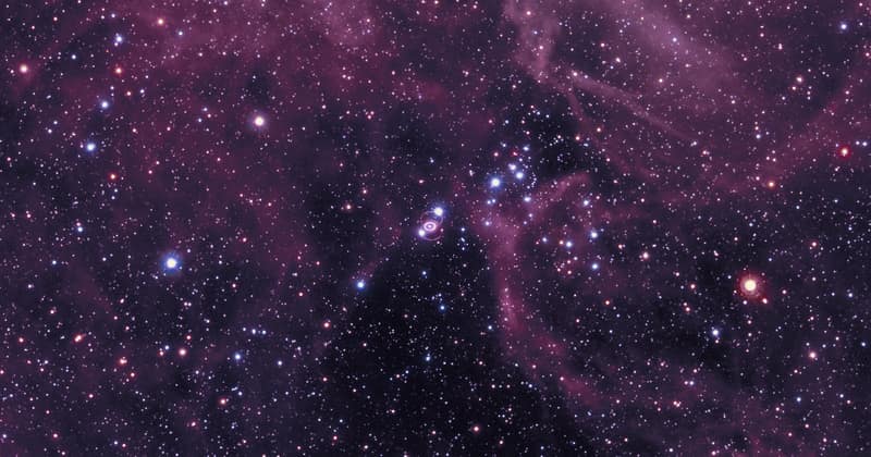 A dense field of stars in the Large Magellanic Cloud, with the small glowing ring of Supernova 1987A near the centre